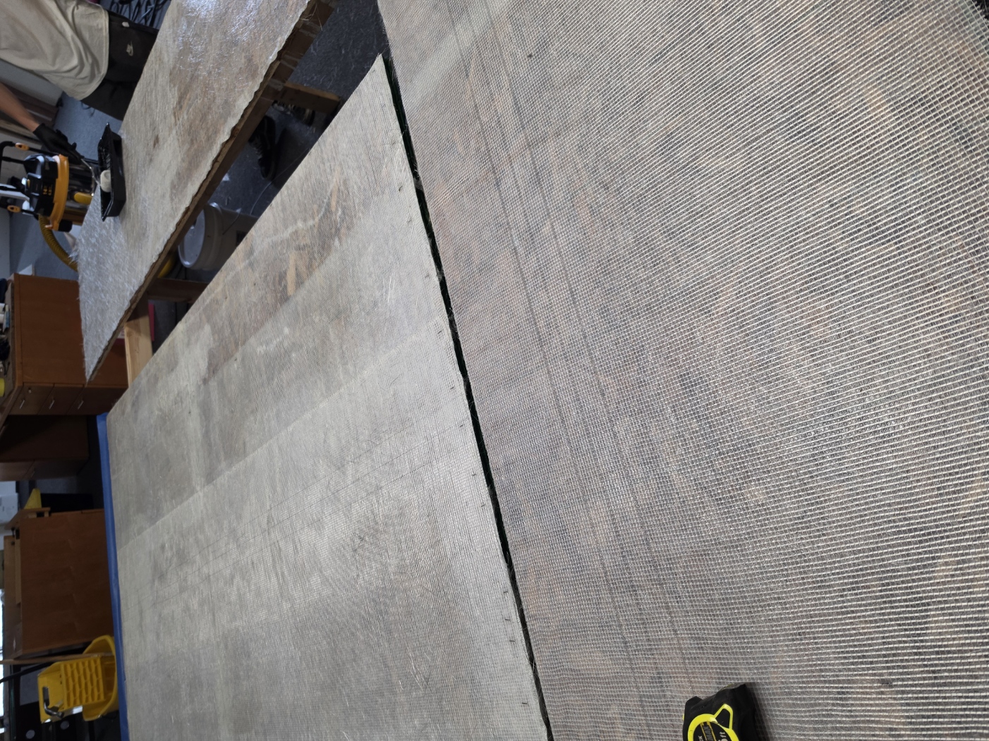 Fiberglass application process during Brickyard shower wall manufacturing