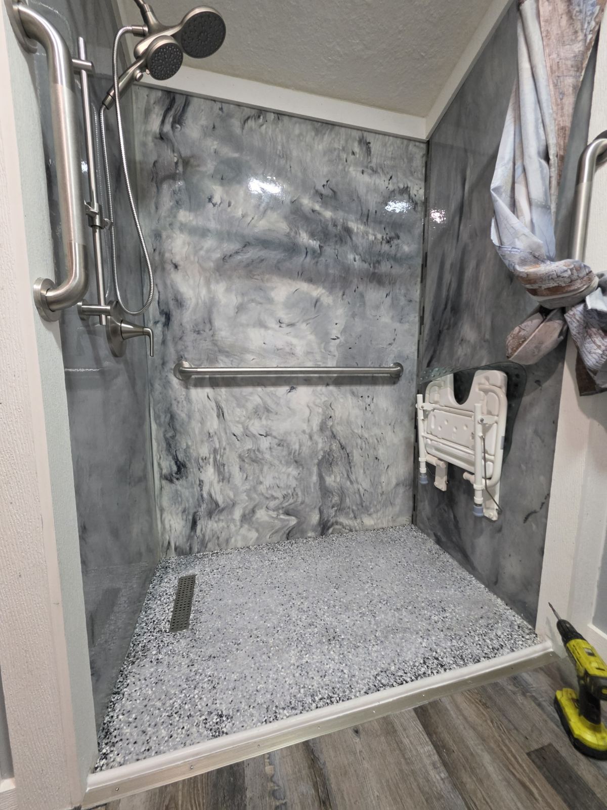 Finished custom composite shower with gray marble-look walls by Brickyard