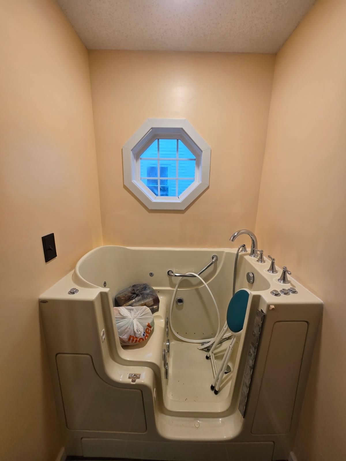 Walk-in bathtub with a side entry door installed in a bathroom